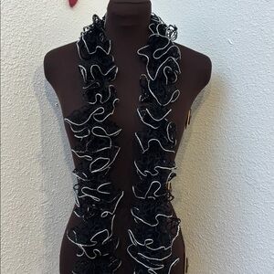 Hand made black crochet spiral ruffle scarf with silver trim.